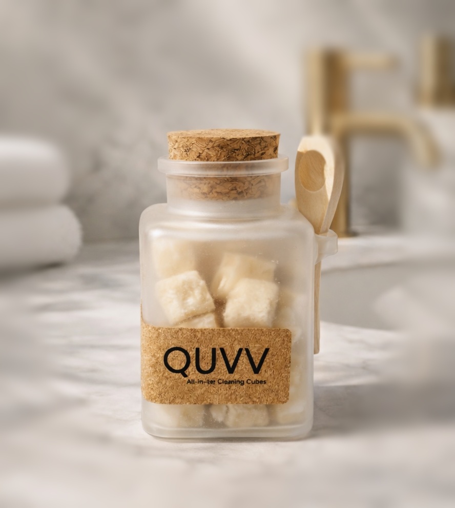 Frosted QUVV jar with cork lid and wooden spoon on marble